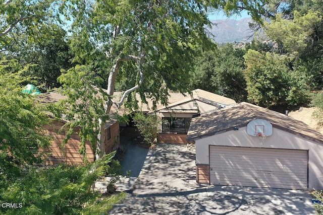 view of front facade with a mountain view and a garage