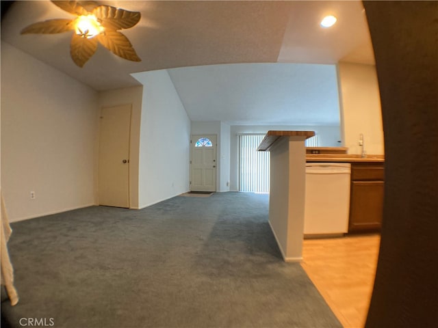 additional living space with ceiling fan, light colored carpet, and vaulted ceiling