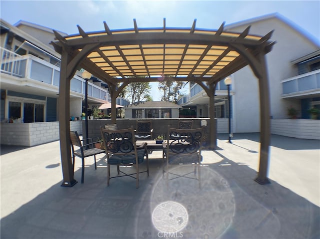 view of patio / terrace featuring a balcony and a pergola