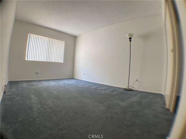 carpeted spare room featuring a textured ceiling