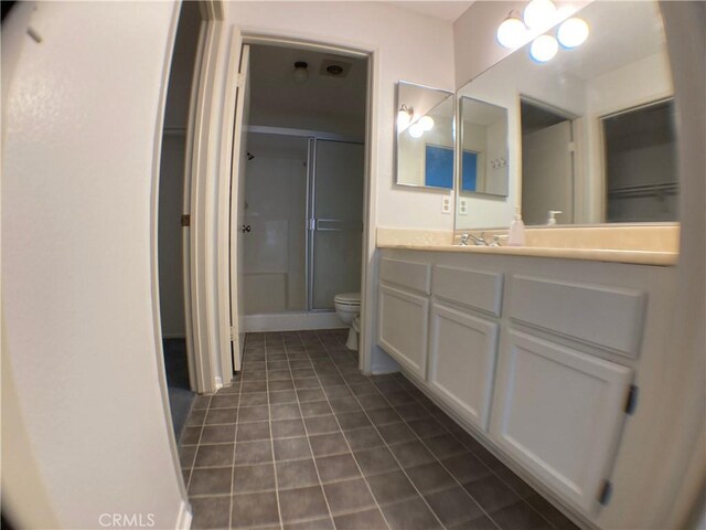 bathroom with vanity, an enclosed shower, and toilet