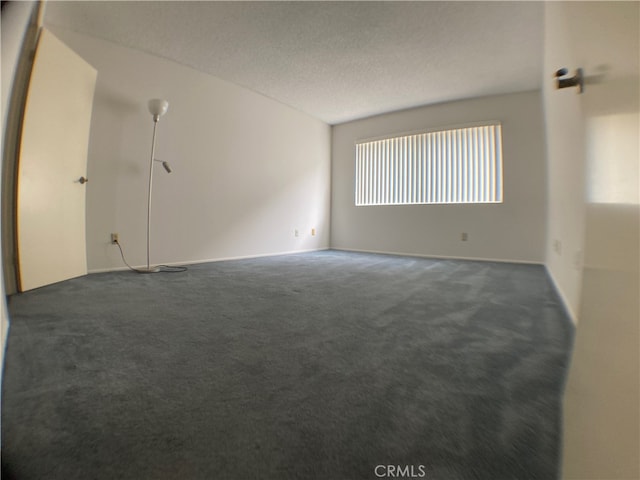 carpeted empty room with a textured ceiling