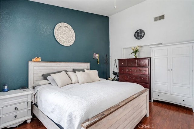 bedroom with dark hardwood / wood-style flooring