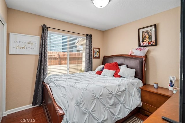 bedroom with dark hardwood / wood-style flooring