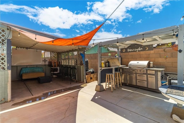 view of patio / terrace featuring area for grilling and an outdoor bar