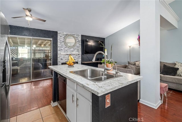 kitchen featuring hardwood / wood-style floors, sink, white cabinetry, and a kitchen island with sink