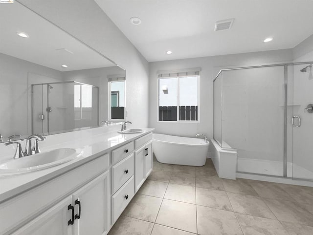 bathroom with tile patterned flooring, vanity, and independent shower and bath