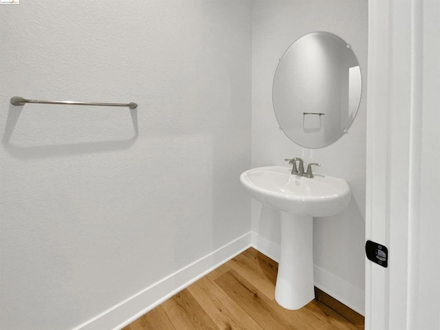 bathroom with hardwood / wood-style flooring and sink