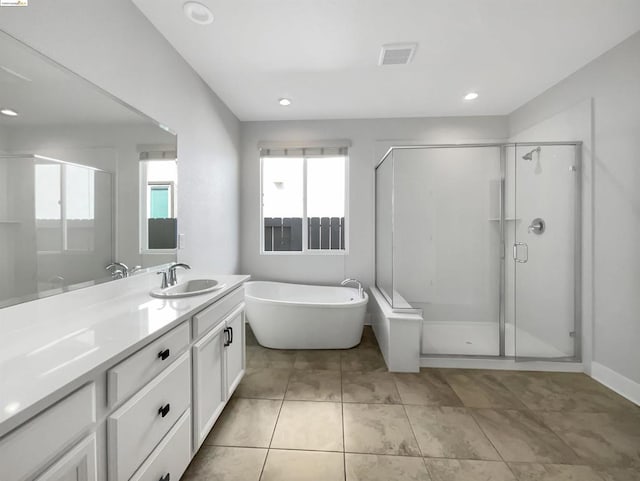 bathroom with vanity and separate shower and tub