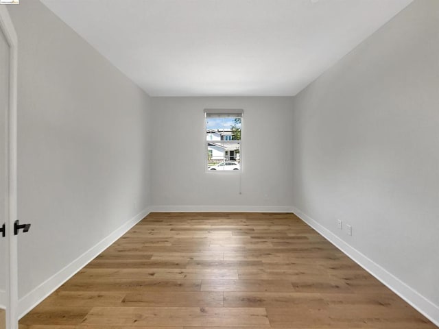 spare room with wood-type flooring