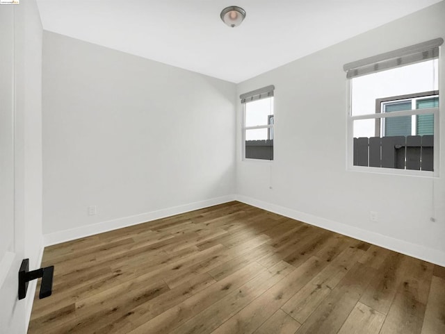 spare room with wood-type flooring