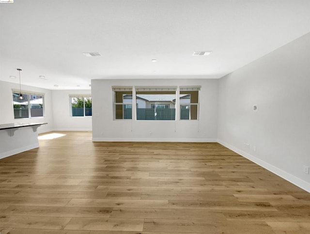 unfurnished living room with light wood-type flooring