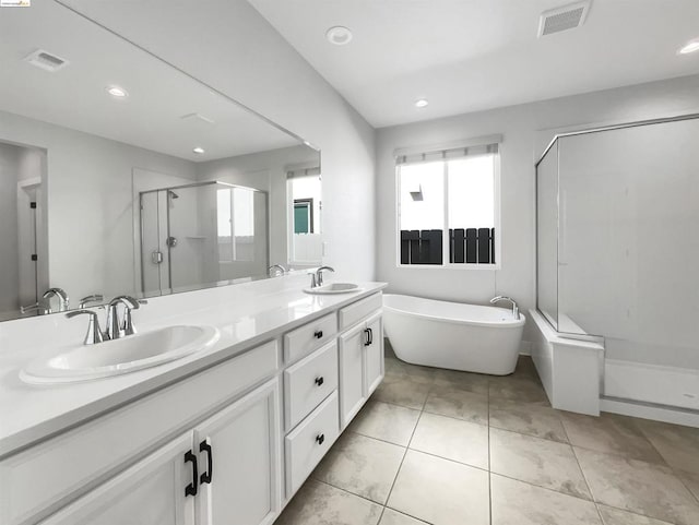 bathroom with tile patterned floors, vanity, and independent shower and bath