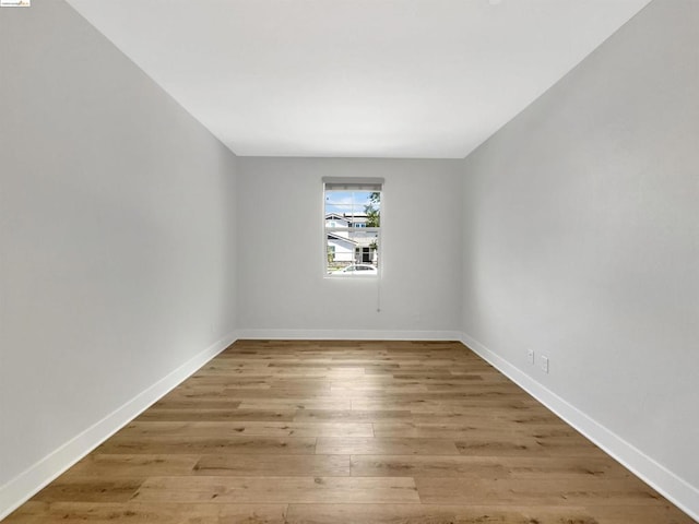 unfurnished room with hardwood / wood-style flooring