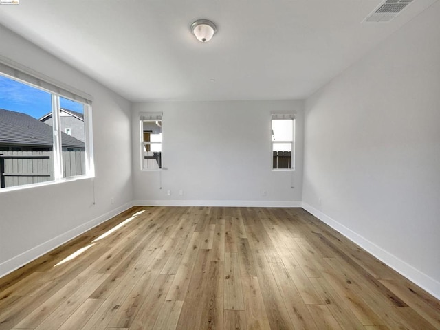 unfurnished room with light hardwood / wood-style flooring and a healthy amount of sunlight