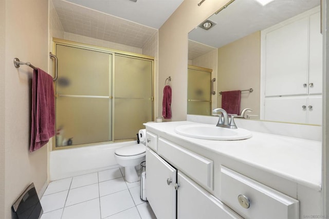 full bathroom with vanity, combined bath / shower with glass door, toilet, and tile patterned floors