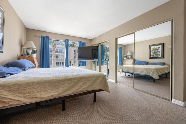 carpeted bedroom featuring multiple closets