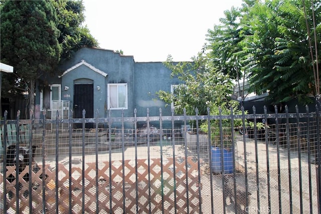 view of front of house with fence and stucco siding