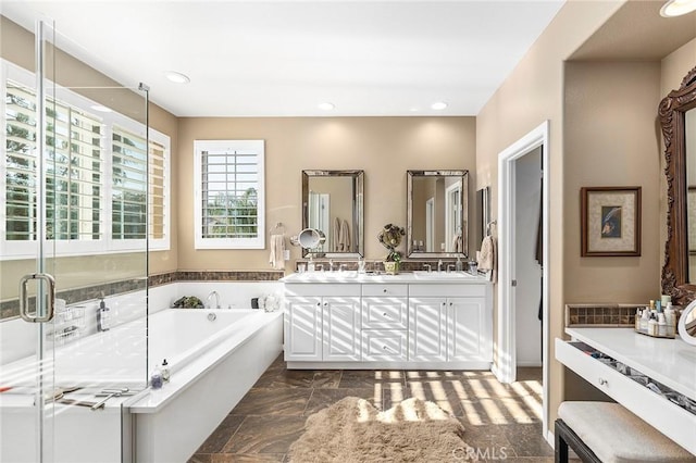 bathroom featuring vanity and independent shower and bath