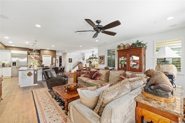 living room with light hardwood / wood-style floors and ceiling fan