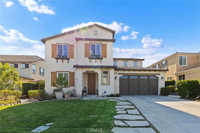 mediterranean / spanish home featuring a garage and a front yard