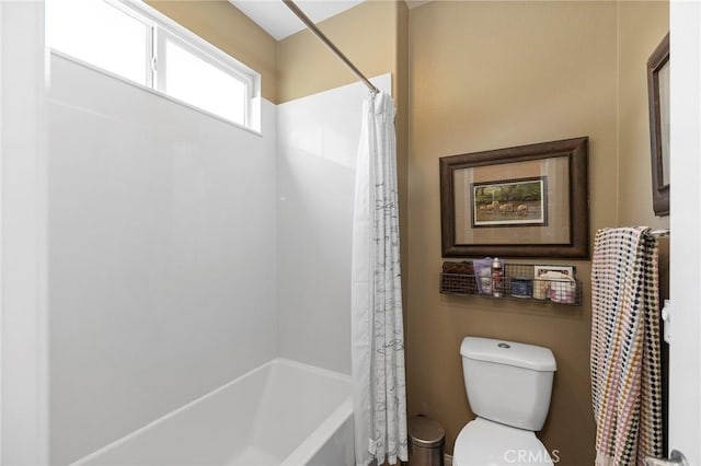 bathroom with shower / bath combination with curtain and toilet