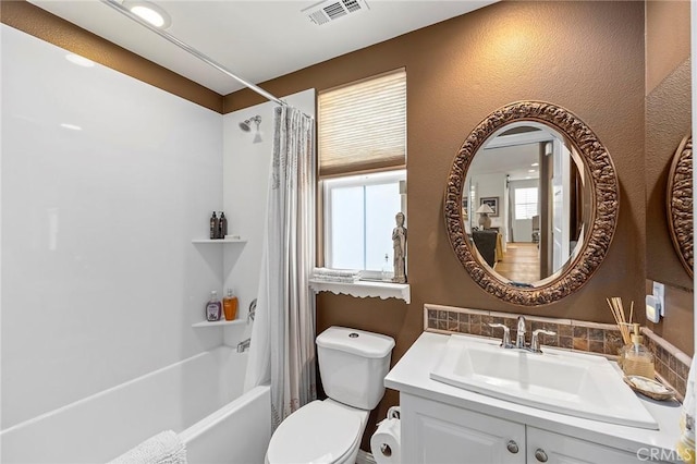 full bathroom with shower / bath combo, vanity, and toilet