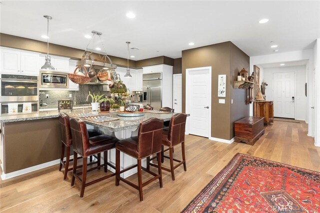 dining area featuring light wood-type flooring and sink