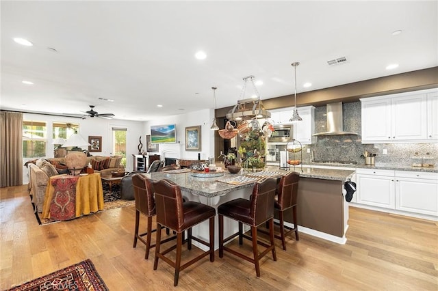 dining room featuring ceiling fan and light hardwood / wood-style floors