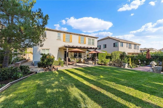 rear view of house with a pergola, a yard, and a patio area