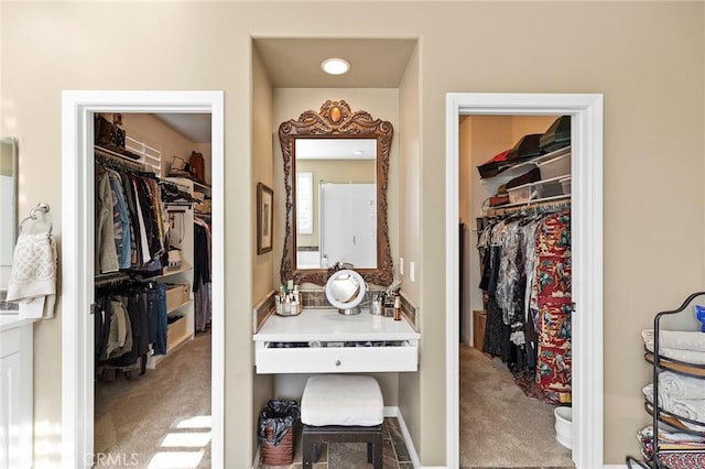 spacious closet with light colored carpet