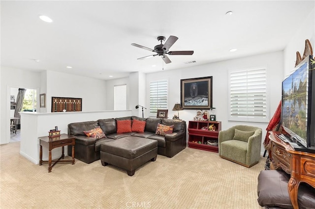 living room featuring light carpet and ceiling fan