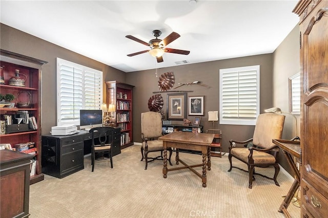 home office featuring ceiling fan and light colored carpet