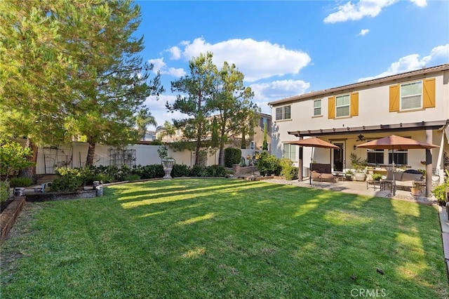 rear view of house featuring a patio area, ceiling fan, and a yard