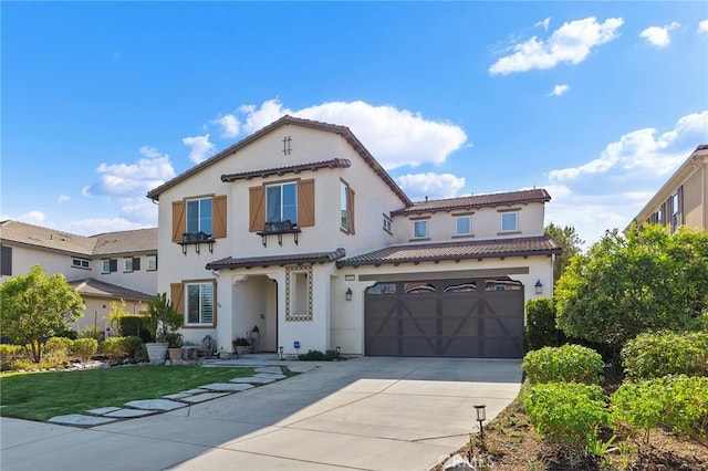 mediterranean / spanish-style house featuring a front yard and a garage