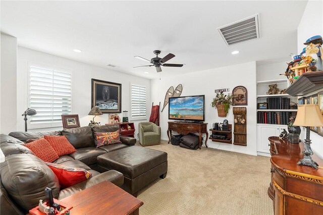 carpeted living room featuring ceiling fan