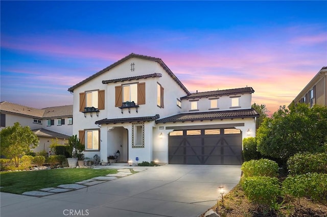 mediterranean / spanish-style home with a garage