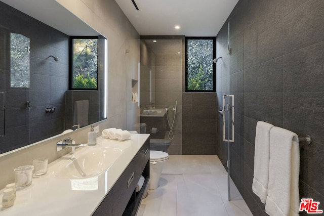 bathroom featuring toilet, tile patterned flooring, tile walls, and a shower