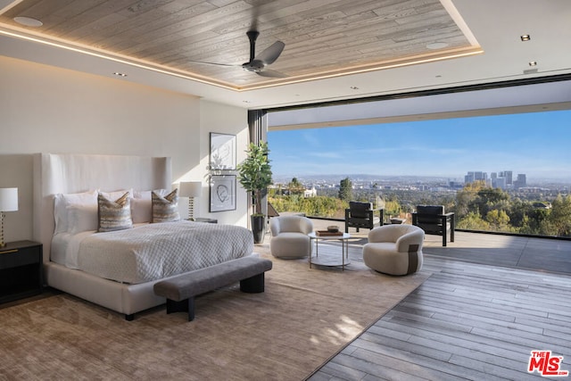 bedroom with hardwood / wood-style floors, wood ceiling, floor to ceiling windows, and ceiling fan