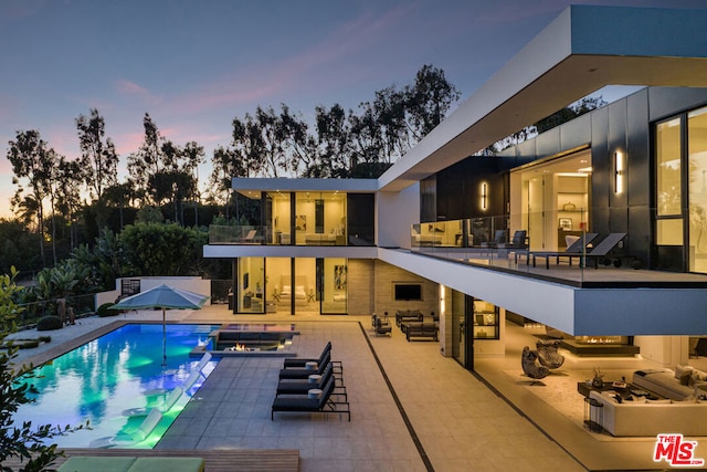 pool at dusk with a patio