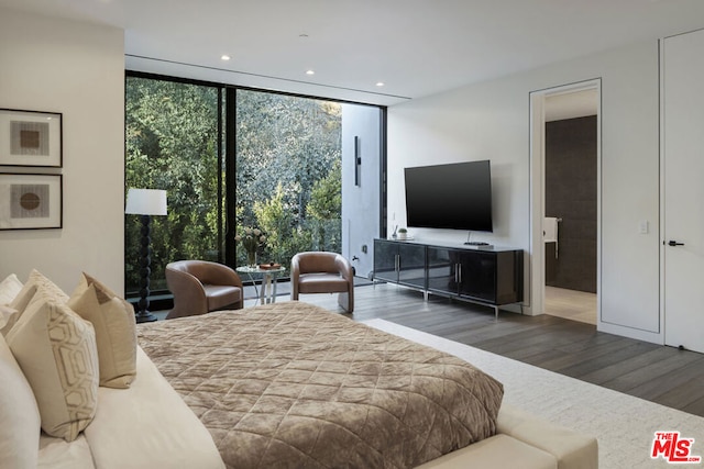 bedroom with dark hardwood / wood-style floors and floor to ceiling windows