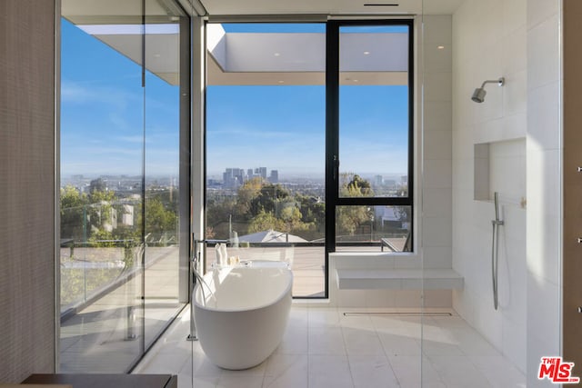 bathroom with tile patterned flooring and a tub