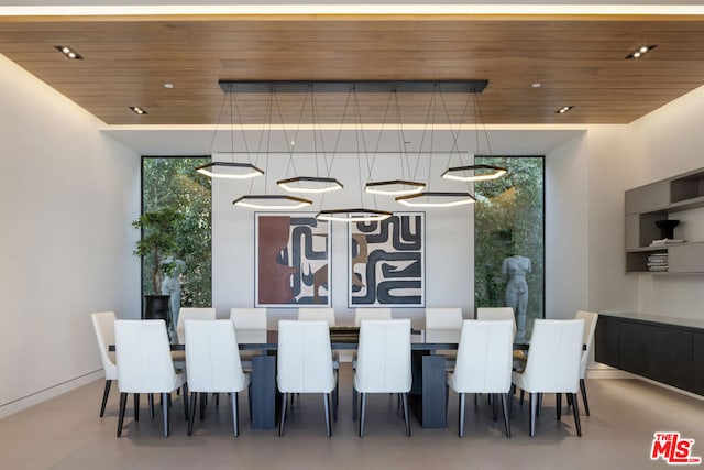 dining space featuring wood ceiling and a wall of windows