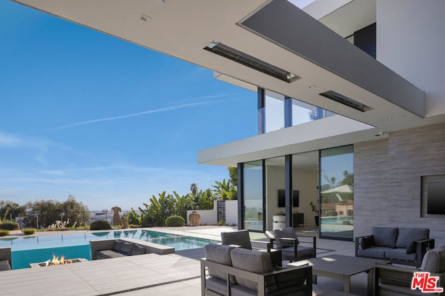 view of pool with outdoor lounge area and a patio