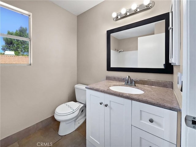 bathroom featuring vanity, tile patterned floors, and toilet