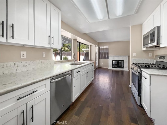 kitchen featuring white cabinets, appliances with stainless steel finishes, and dark hardwood / wood-style flooring