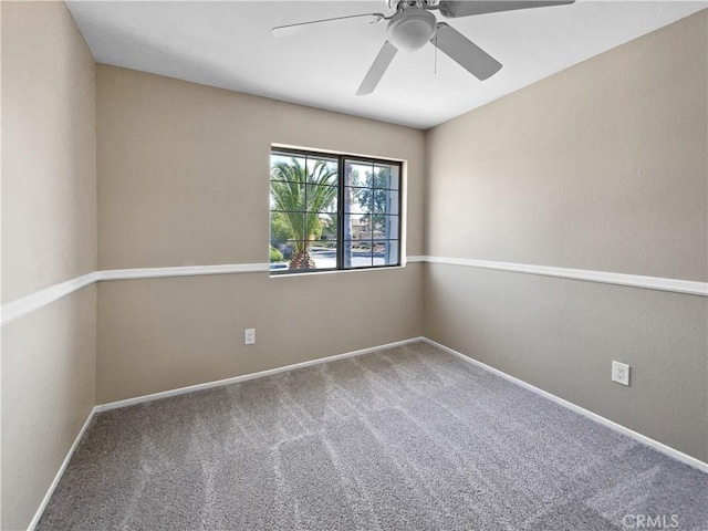 empty room featuring ceiling fan and carpet floors