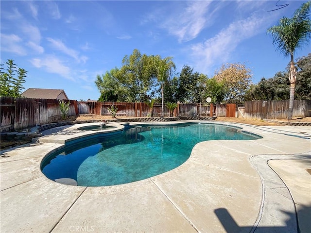 view of swimming pool featuring an in ground hot tub and a patio area