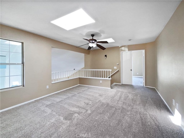 spare room featuring carpet floors and ceiling fan