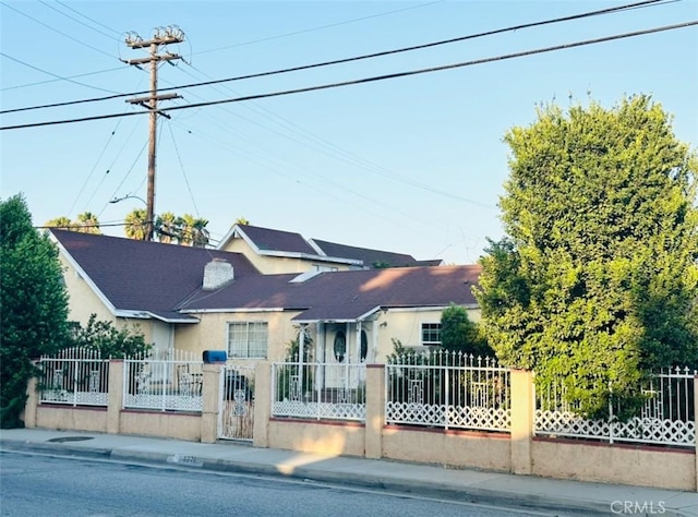 view of front of house with a fenced front yard and stucco siding